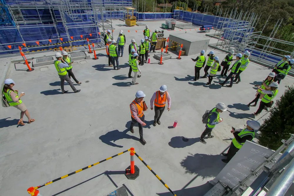 A construction crew in hi-vis gathered for a site induction